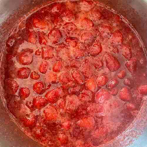 Strawberries after having been cooked 5 minutes to make homemade strawberry jello.