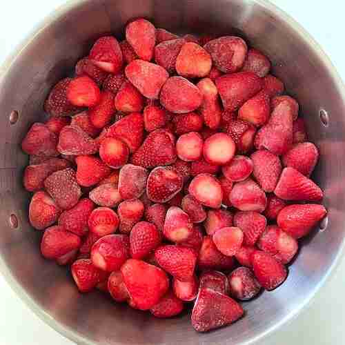 Strawberries in a pot to make homemade strawberry jello.