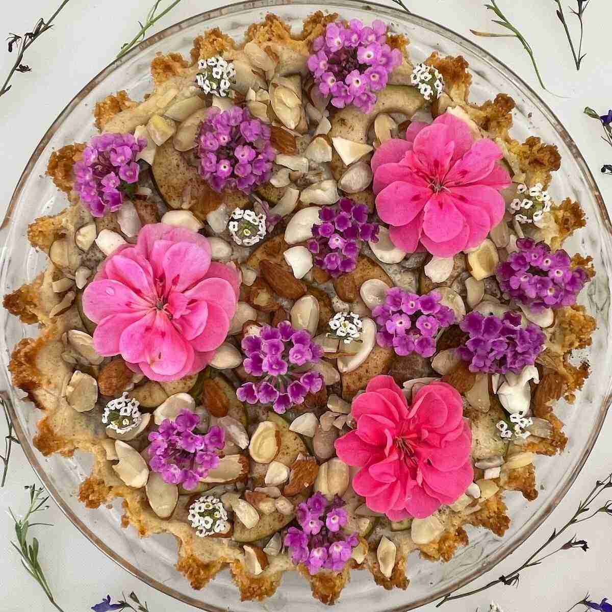 Benefits of baking and music include inspiring creative pies such as this unique sugar free pear pie topped with fresh pink and purple flowers from the garden.