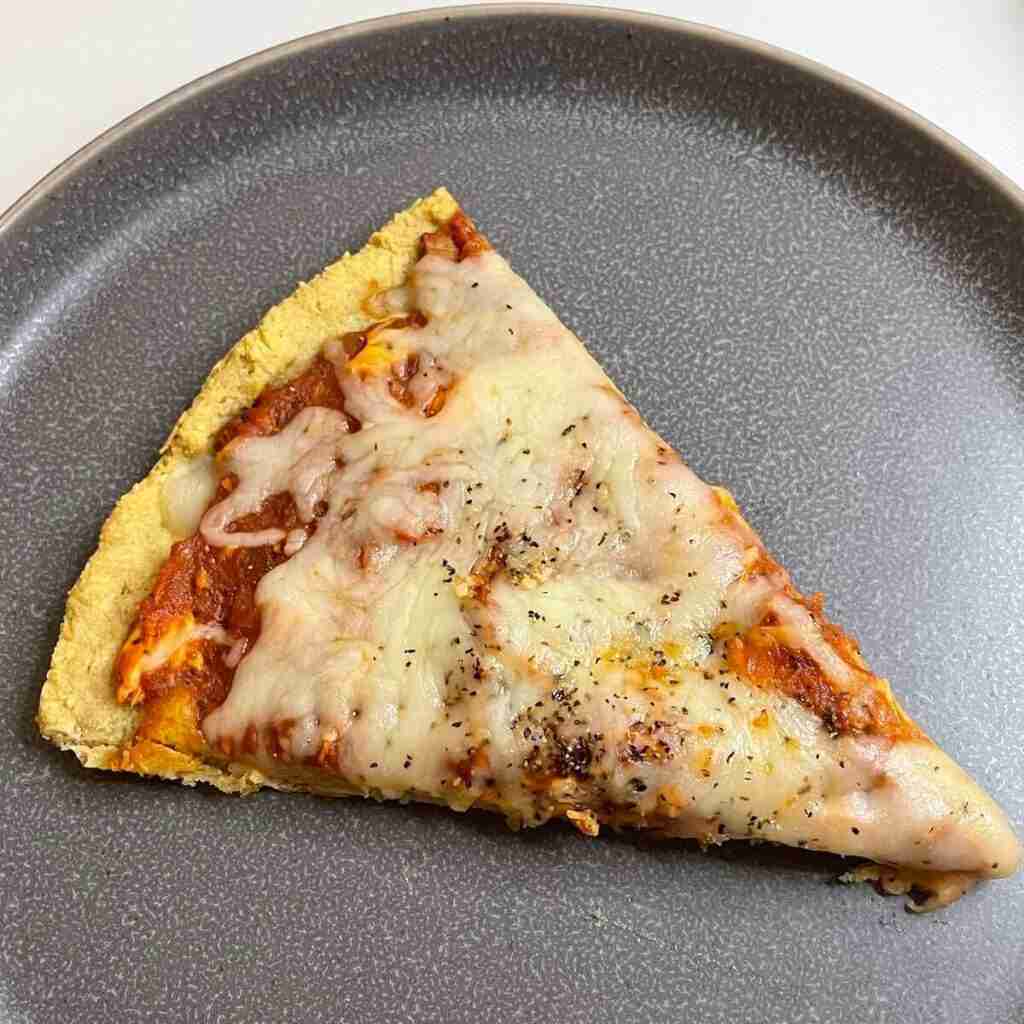 A slice of Gluten-Free Pizza Margarita on an almond flour crust