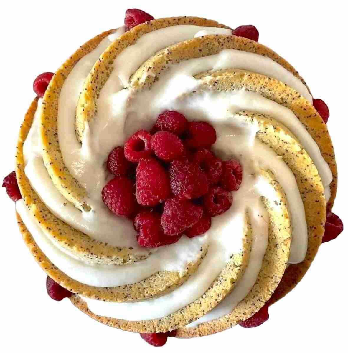 KETO lemon poppy seed cake with lemon icing and raspberries in the center photographed from above.