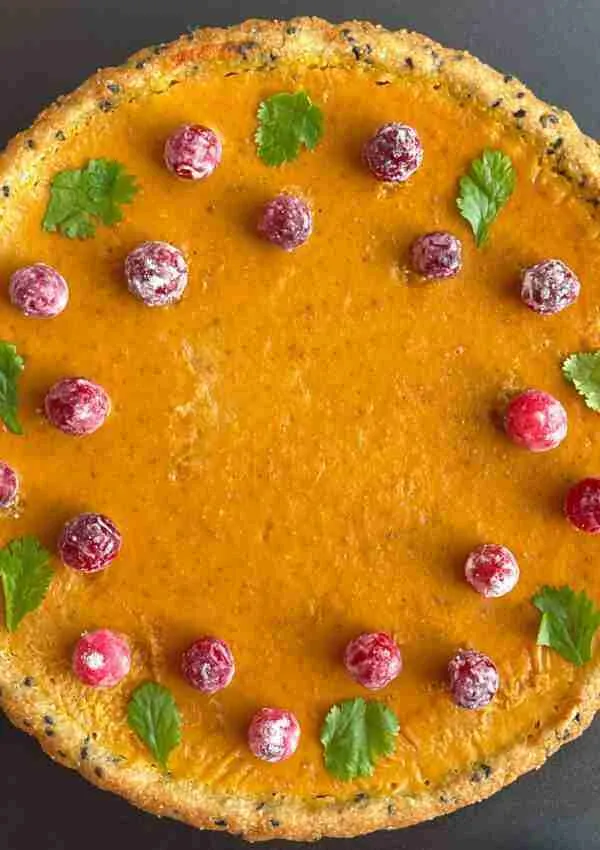 The perfect healthy pumpkin pie in a black sesame, almond flour crust, topped with cranberries powdered in monk fruit.