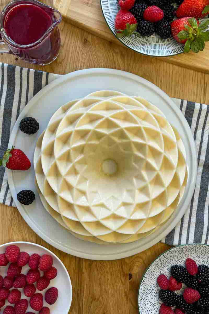 An undecorated milk jello cake made in a Nordic Ware bundt cake pan.