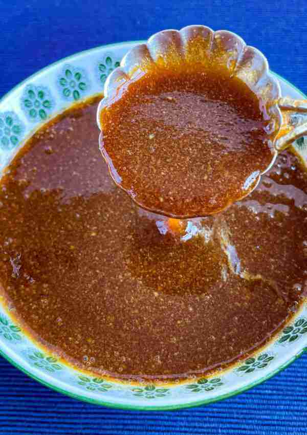 A spoonful of sugar free teriyaki sauce held over a bowl of this diabetic teriyaki sauce.