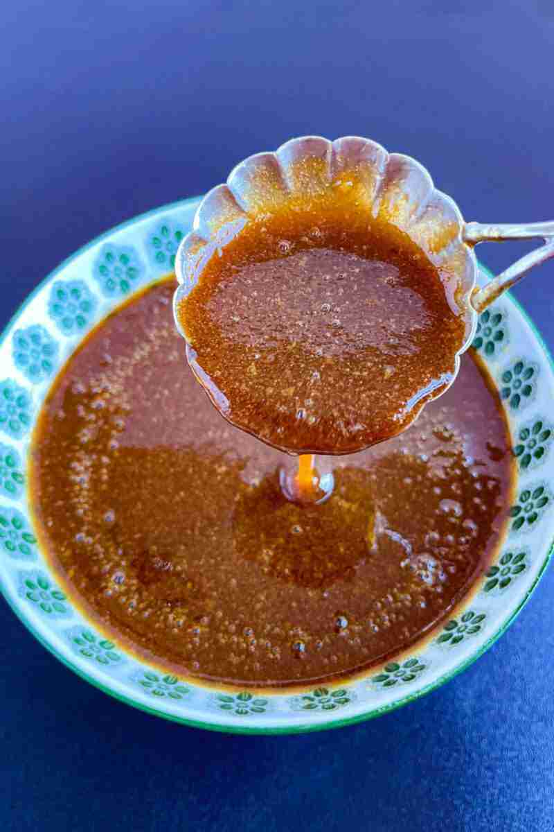 A spoonful of thick and creamy homemade teriyaki sauce without sugar above a bowl.