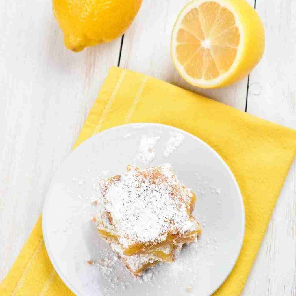 3 lemon bars on a plate.