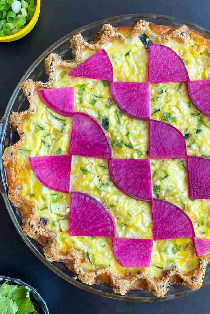 A baked, low-carb Salmon Teriyaki Keto Quiche topped with beautiful magenta watermelon radishes.