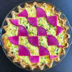 A baked, low-carb Salmon Teriyaki Keto Quiche topped with beautiful magenta watermelon radishes.
