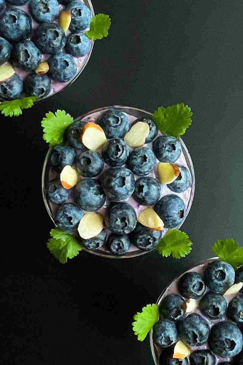 A cup of vegan sugarfree blueberry pudding or homemade blueberry soy yogurt.