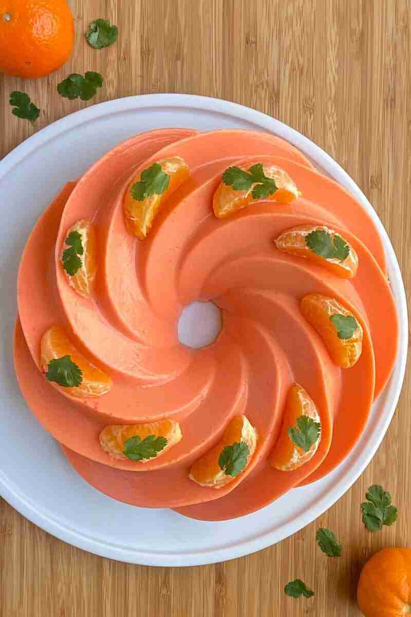 Orange cream gelatin cake, also called orange milk jello, topped with fresh mandarin slices.