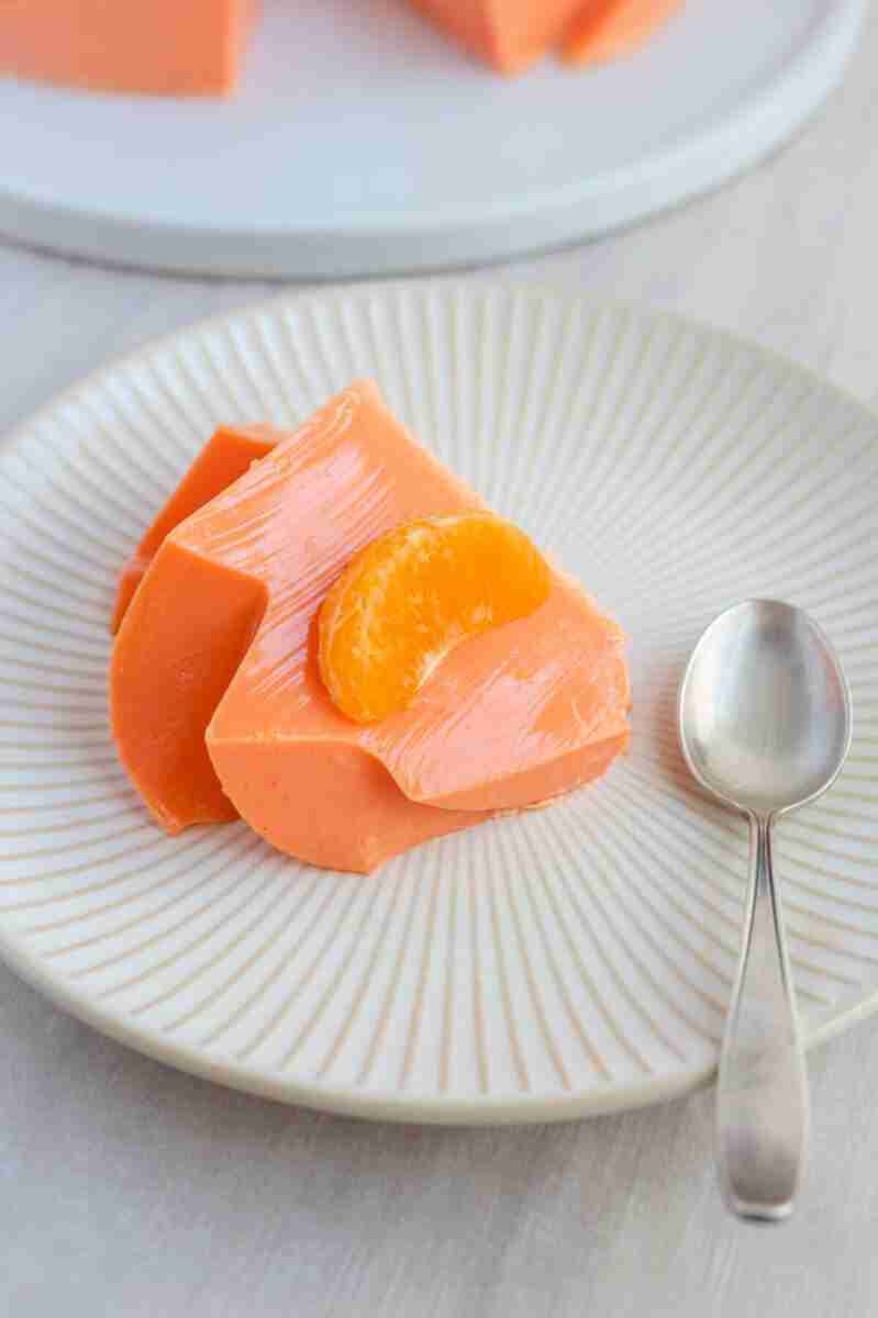 A slice of this dessert topped with a mandarin.