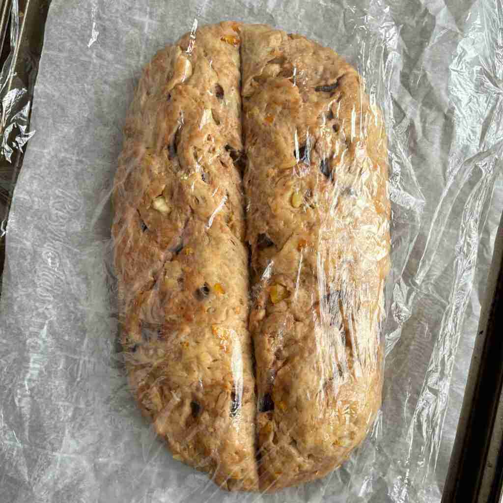A step in the Christmas stollen recipe where the stollen rises a second time and is covered with plastic wrap.
