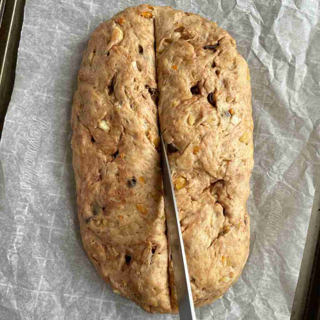 The step where you slice the top of the Stollen with a knife so the German Christmas bread opens up a bit when it bakes.