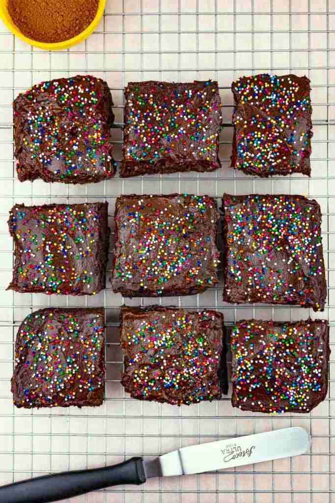 Paleo, keto, healthy chocolate dessert squares with healthy chocolate avocado frosting and sugar-free sprinkles.