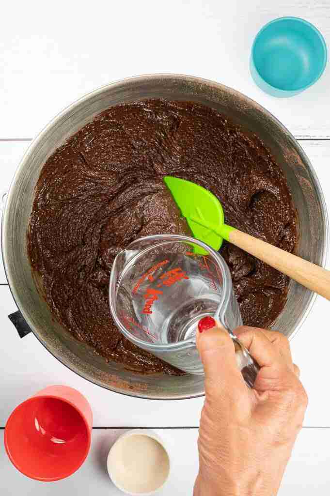 Step 4 to make black forest cake with cherries.