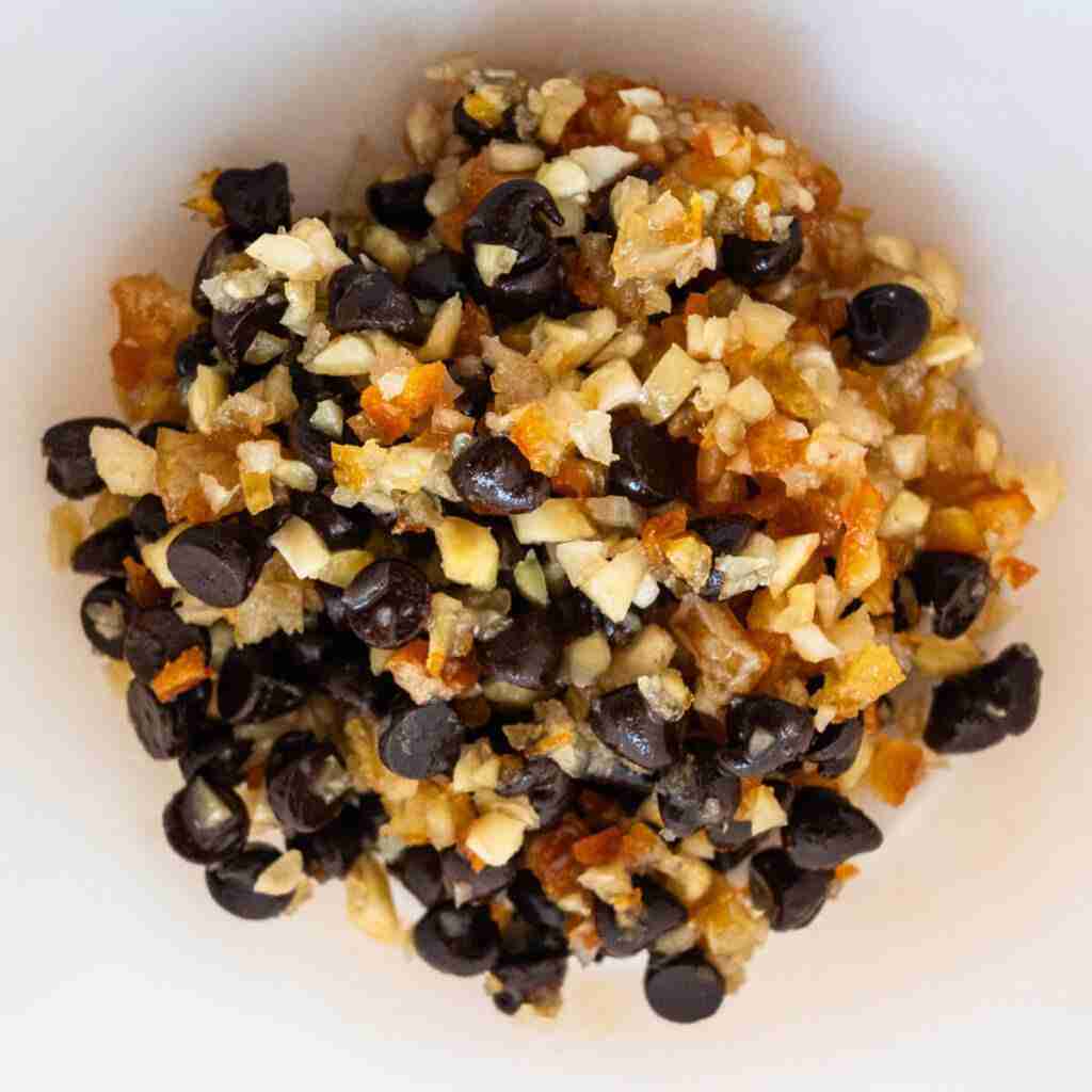 A step in the recipe: Marinating the chocolate chips, citrus peels and chopped almonds in rum.