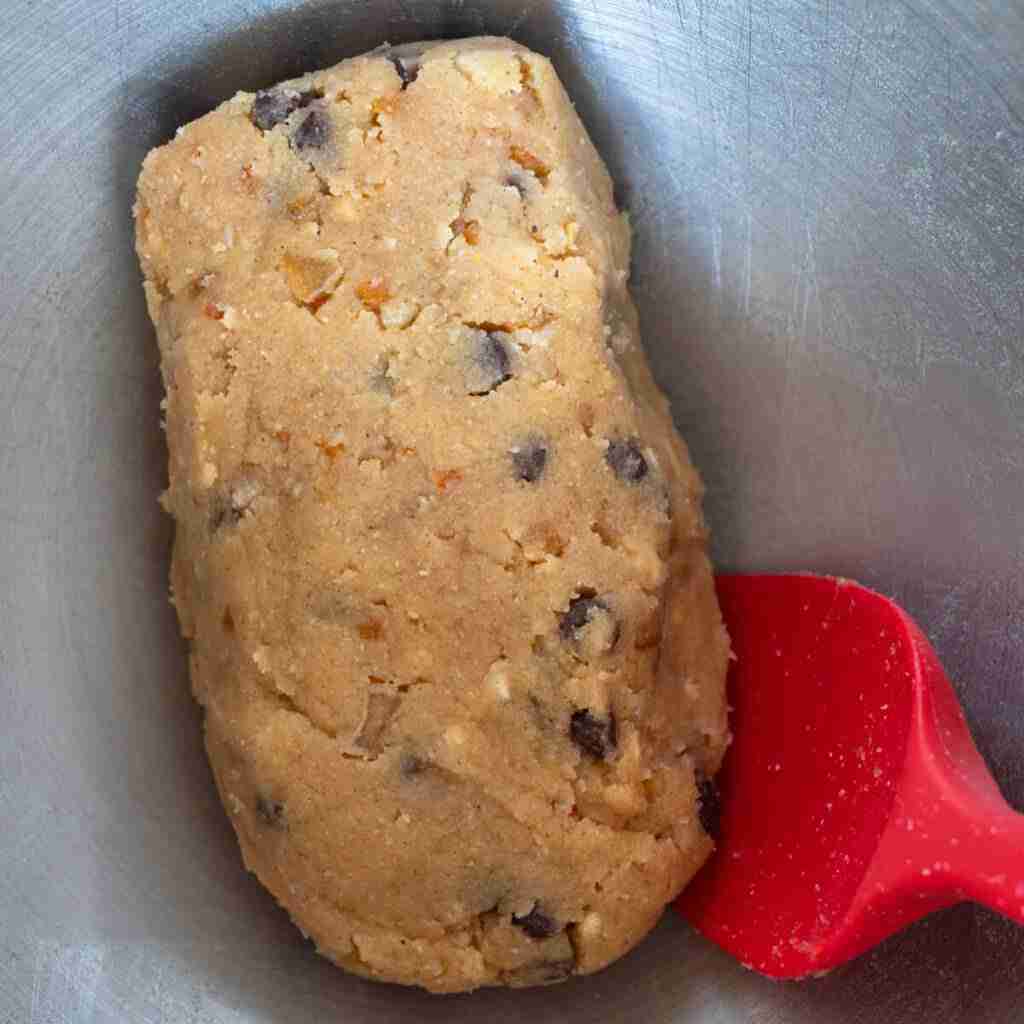 Step 6 in the recipe: Shaping the gluten free Stollen dough into a loaf.