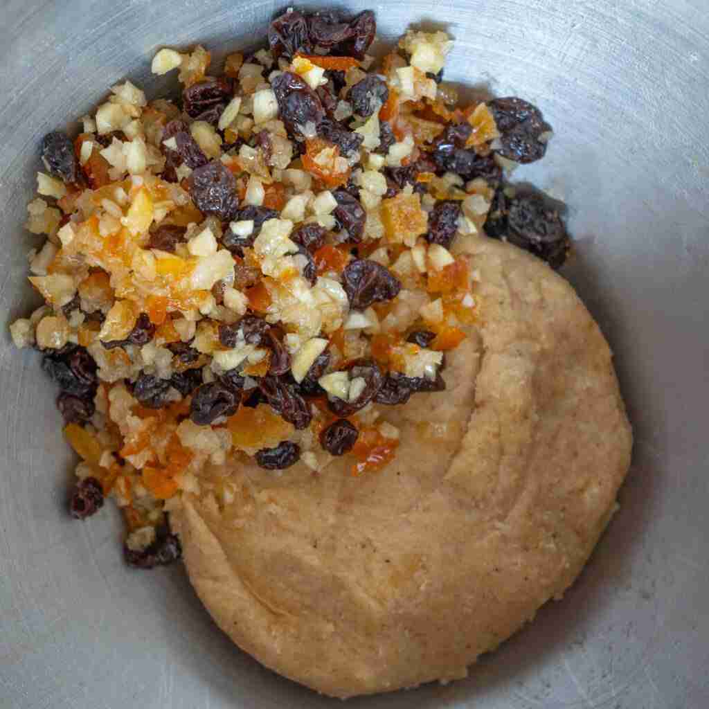 Step 5 in the low carb Stollen recipe: Mixing the marinated raisins and gluten free dough.