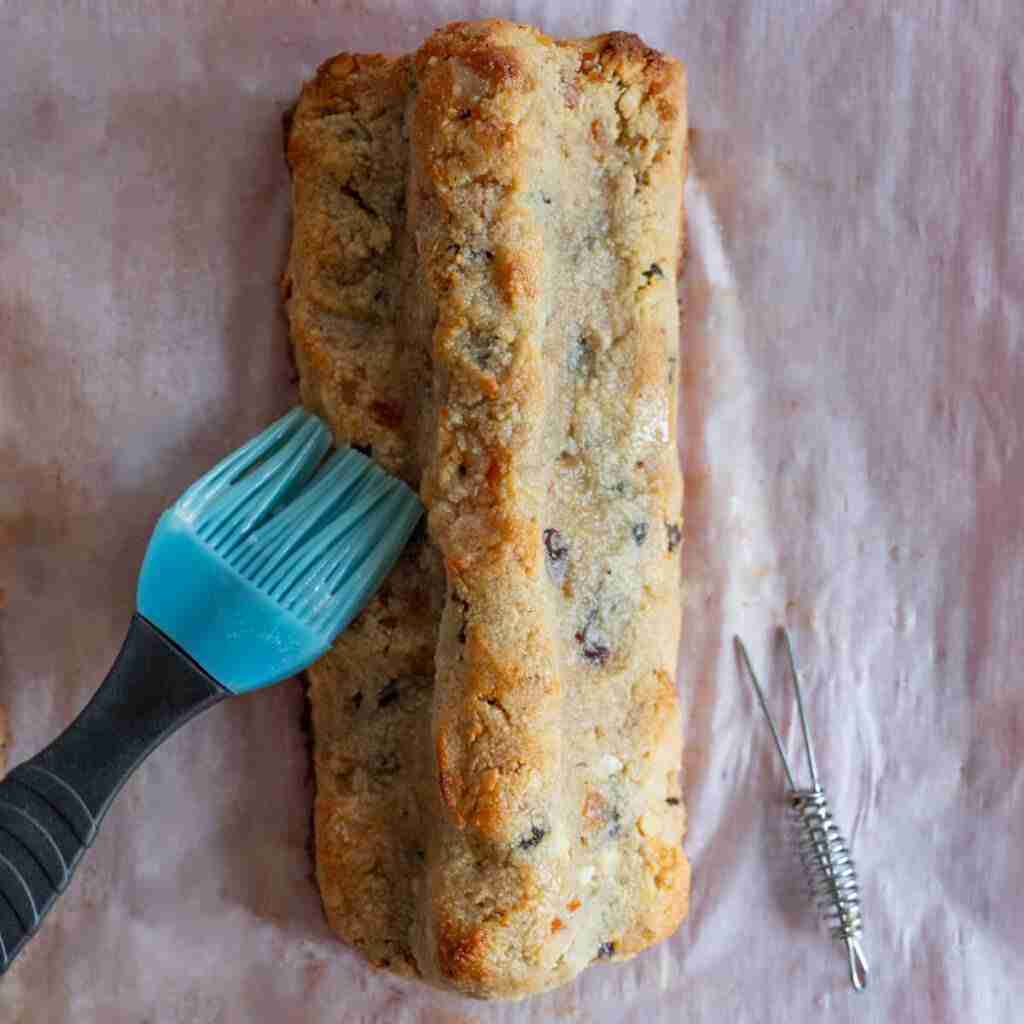 A step in the recipe: Brushing the Mini Stollen with melted butter.