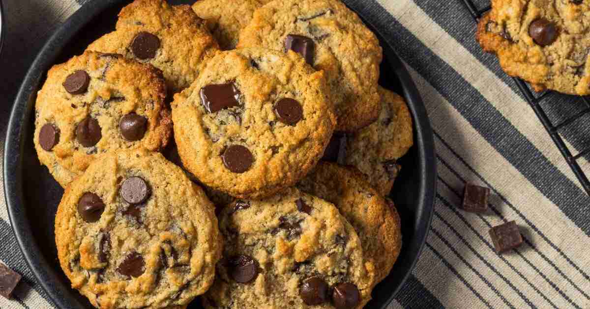 Sugar-Free Vegan Peanut Butter Chocolate Chip Cookies on a plate and cooling rack.