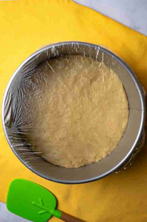 A step in the recipe: Cover the dough with plastic wrap and let it rise again.