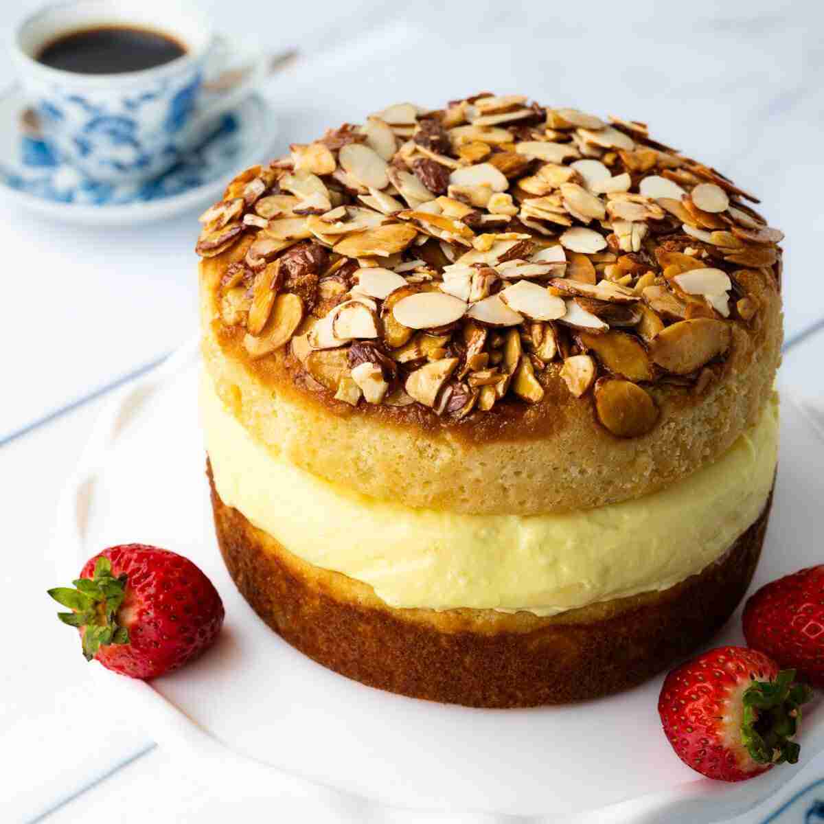 Keto Almond Cake, also called low-carb Bee Sting Cake, with a vanilla pudding filling and topped with a honey-almond glaze.