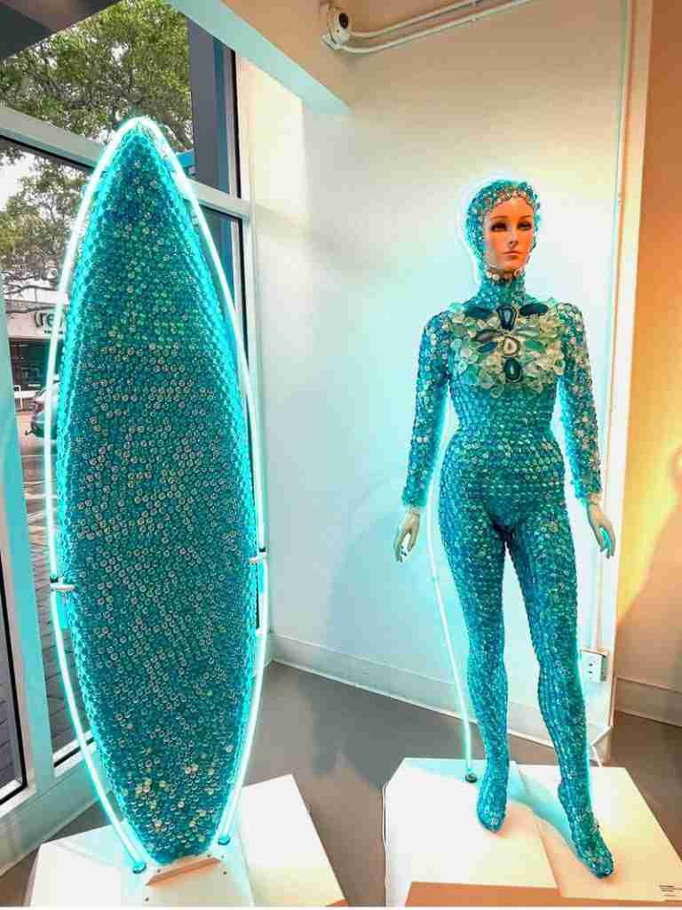 A mannequin in blue sequins with a blue-sequin surfboard on exhibit at the Imagine Museum in Florida.