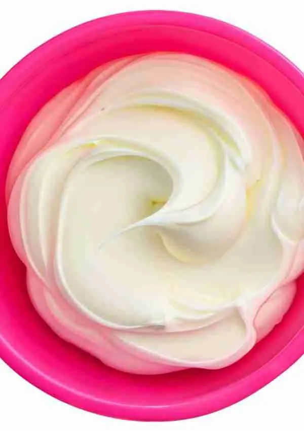Keto cream cheese frosting in a pink bowl.