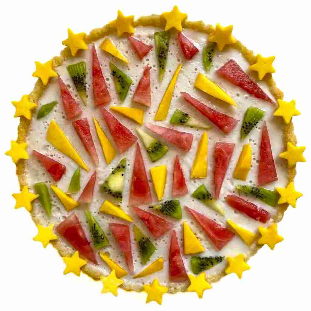 vegan fruit tart with geometric watermelon spikes and mango stars.