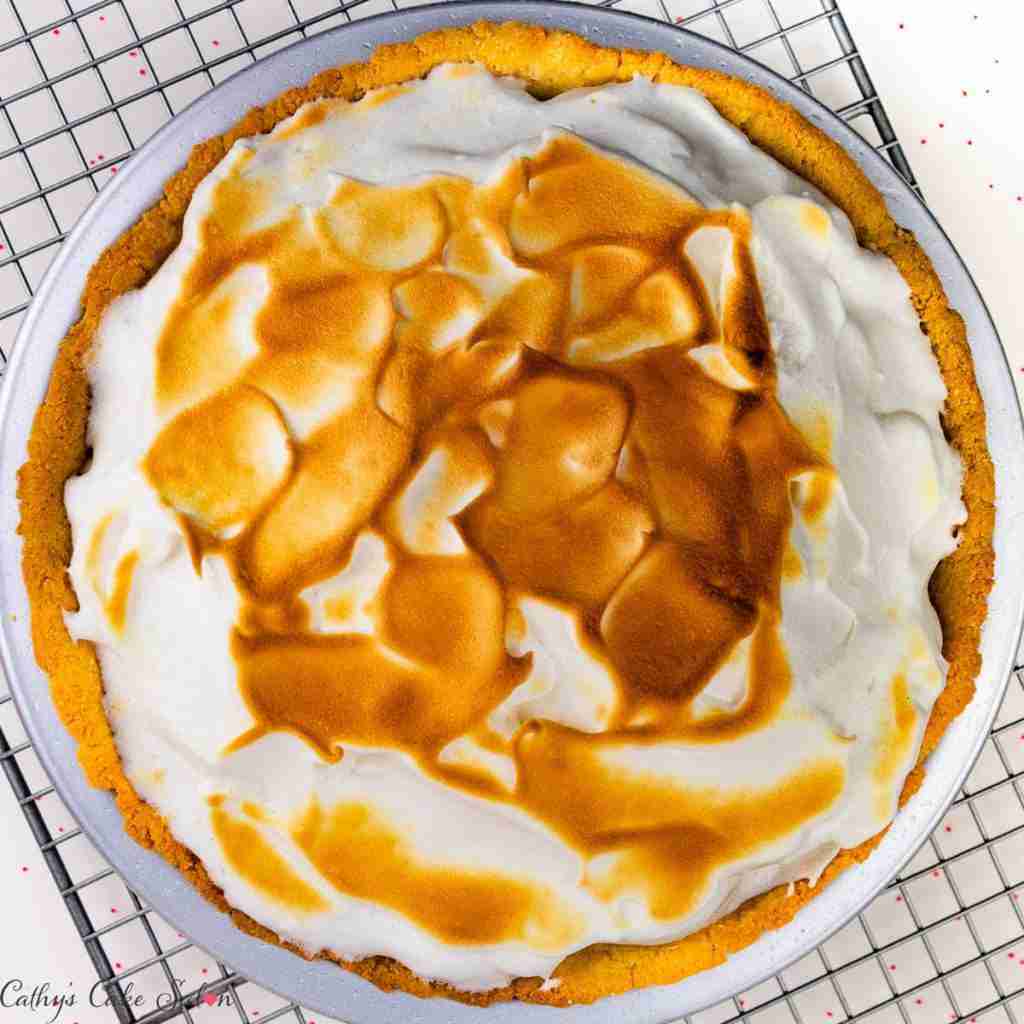 A step in the recipe: The finished tart with carmelized peaks browned by a blow torch on a cooling rack.