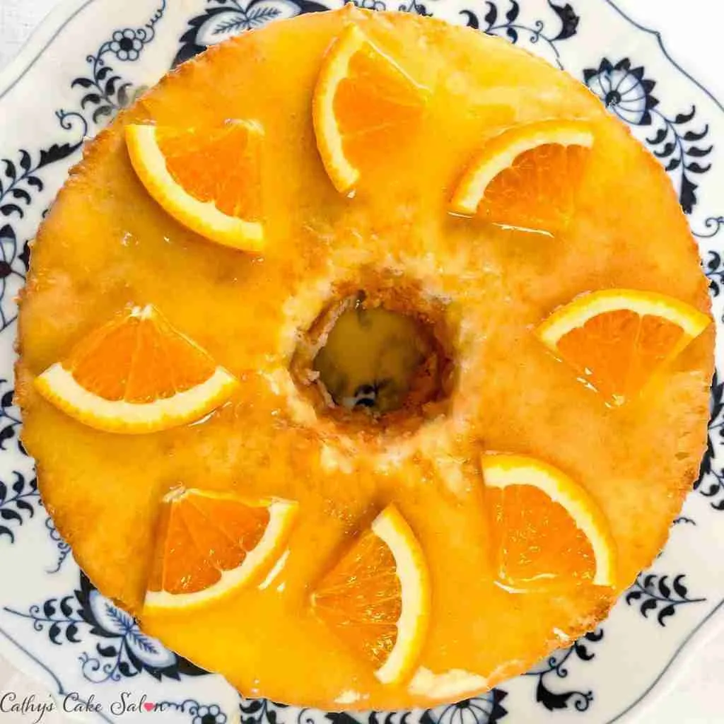Orange keto angel food cake with sugar free orange glaze and fresh oranges.