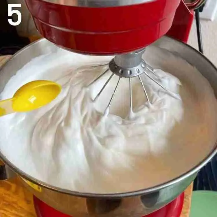 A step in the recipe: Whip the egg whites while adding orange and vanilla extract.