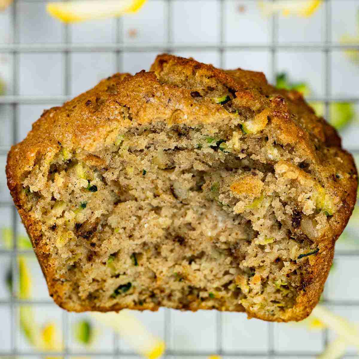 A single sugar free protein zucchini muffin cut in half, so you see the interior.