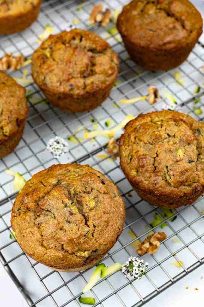 Sugar free protein zucchini walnut muffins on a cooling rack.