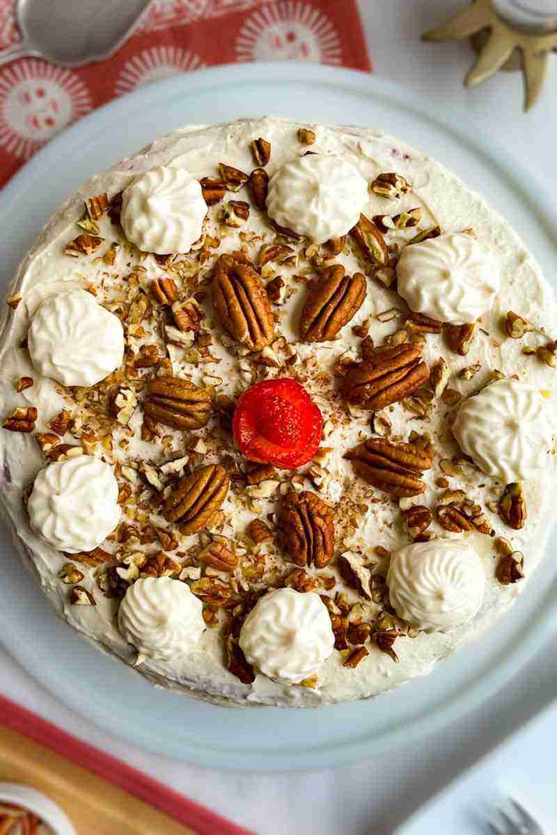 A sugar free red velvet cake topped with keto cream cheese frosting, pecans and a strawberry. This is a keto and diabetic red velvet cake recipe.
