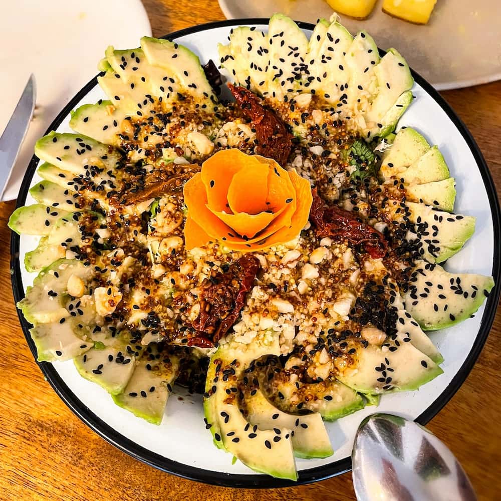 Best Cabanyal restaurants: Avocado salad with macadamia nuts and sun-dried tomatoes in a lime vinaigrette at Cienfuegos in the El Canyamelar district of Valencia, Spain.