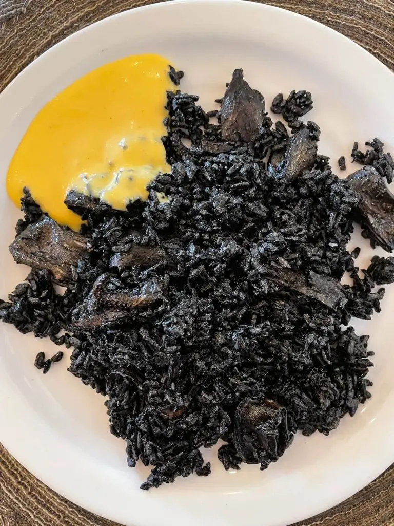 Black rice with squid and seafood at La Bodeguita del Cabanyal restaurant in Valencia, Spain.