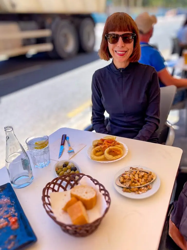 The author at an outside table eating calamari at Bodega La Pascuala restaurant in the El Cabanyal, Spain.