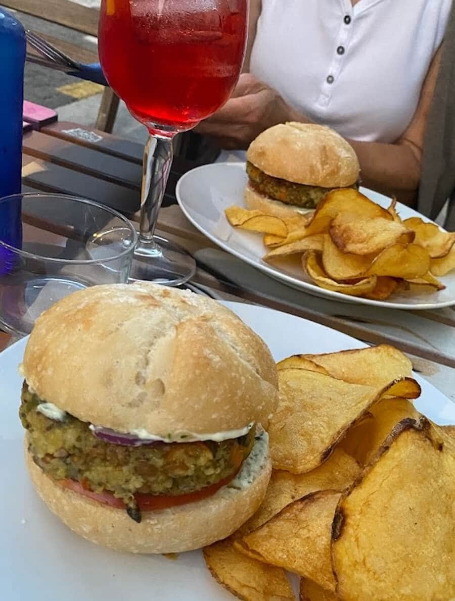 Vegetarian burgers with potato chips and an aperol spritz at La Batisfera Restaurant in El Cabanyal, Valencia, Spain.