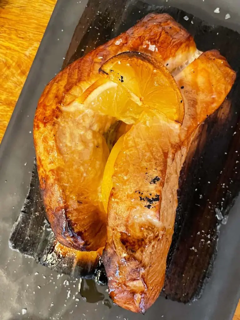 Best El Cabanyal restaurants: Salmon on cedar wood at Cienfuegos in the Cabañal-Cañamelar quarter of Valencia, Spain.