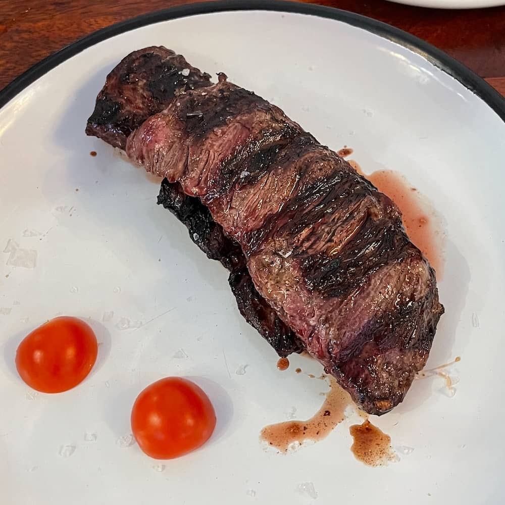 Best El Cabanyal restaurants: Skirt steak with baby tomatoes at Cienfuegos in Valencia, Spain.