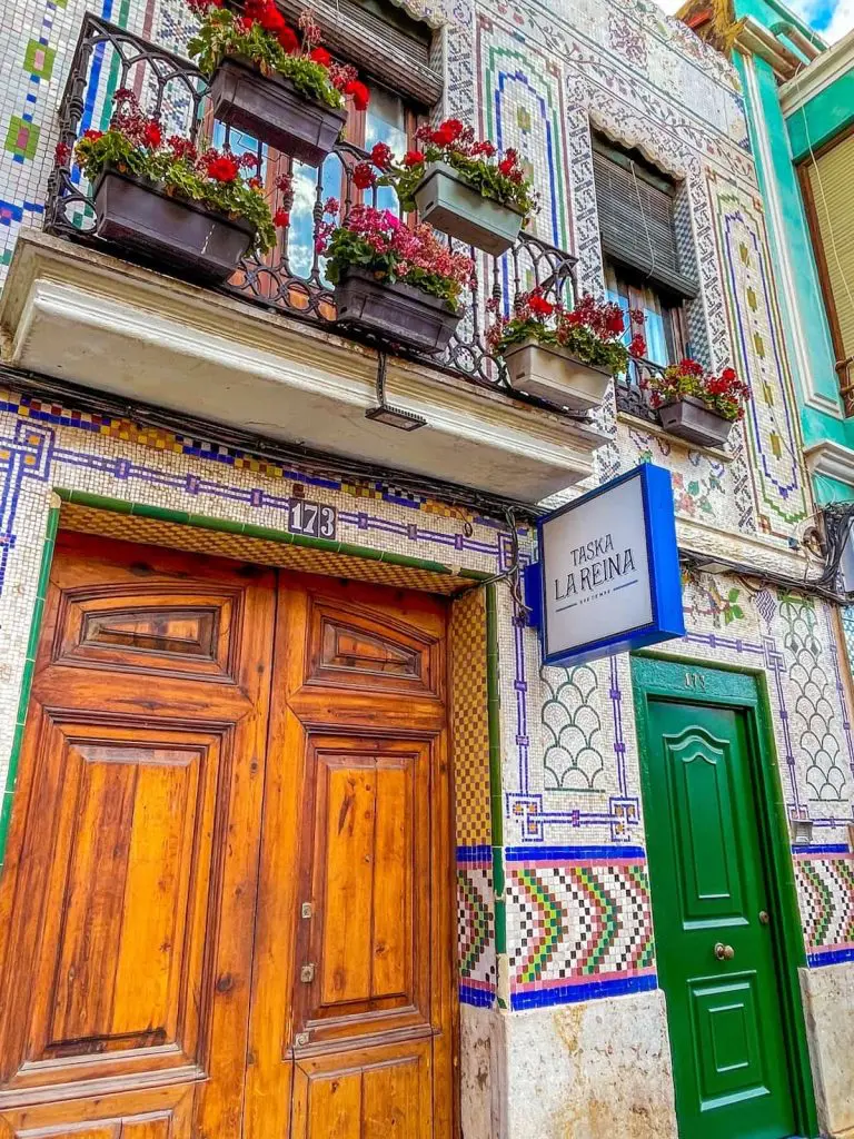 The tiled facade of one of the best Cabanyal restaurants: Taska La Reina in Valencia, Spain.