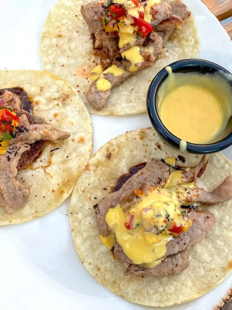 Best Cabanyal restaurants: Iberian pork tacos with black mole, pico de mango and yellow pepper mayonnaise.