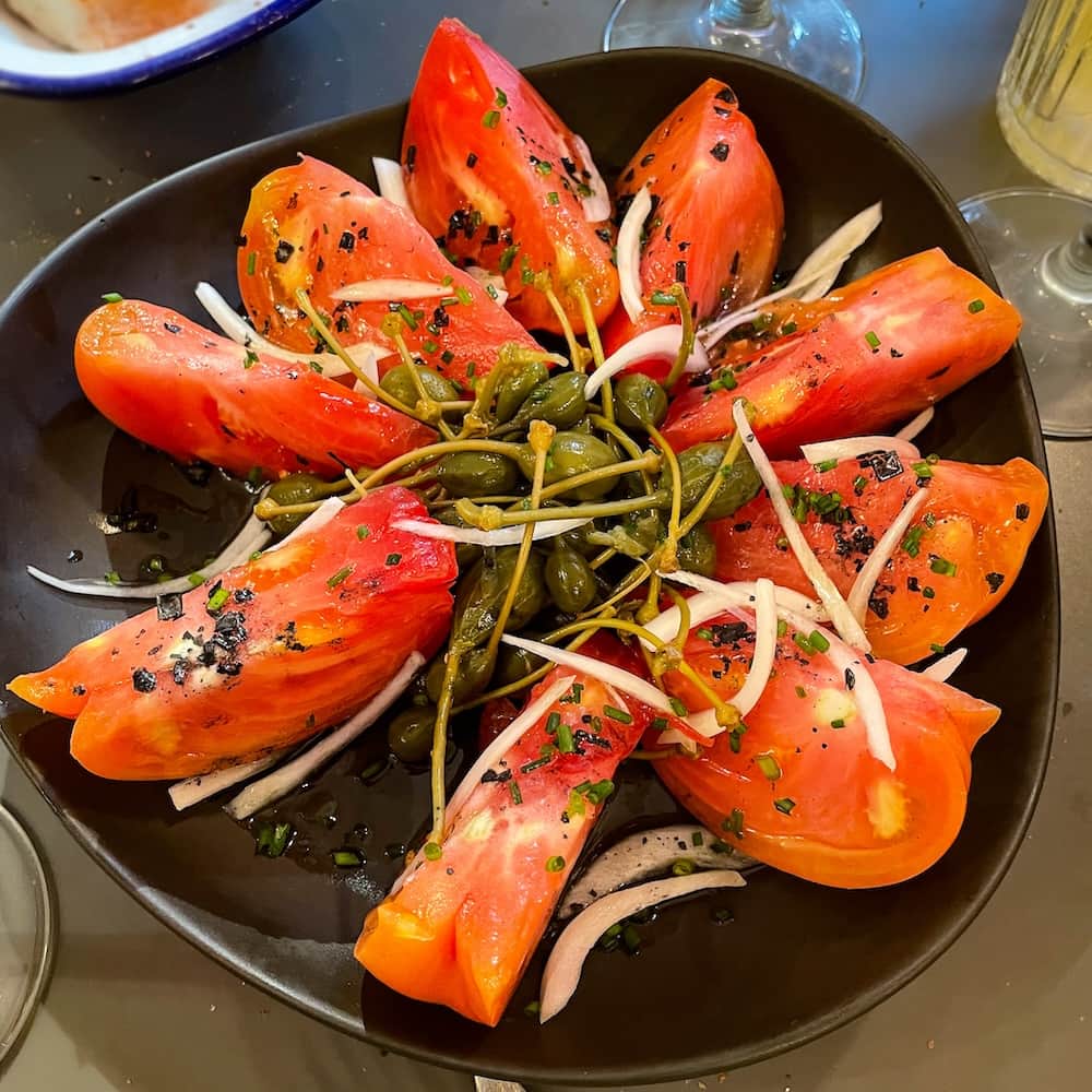 Best restaurants el Cabanyal Valencia: Tomato salad with capers at Cienfuegos in the Cabañal-Cañamelar quarter of Valencia, Spain.