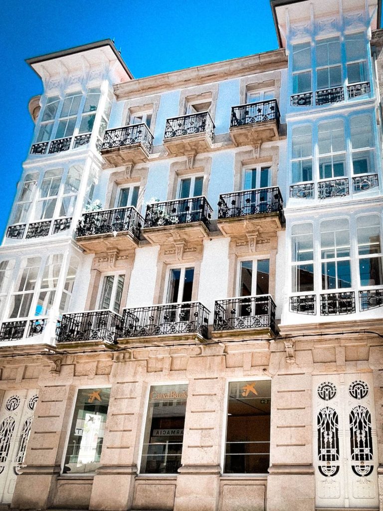 A historic house with regular balconies and glassed-in balconies in Ferrol, Galicia, Spain.