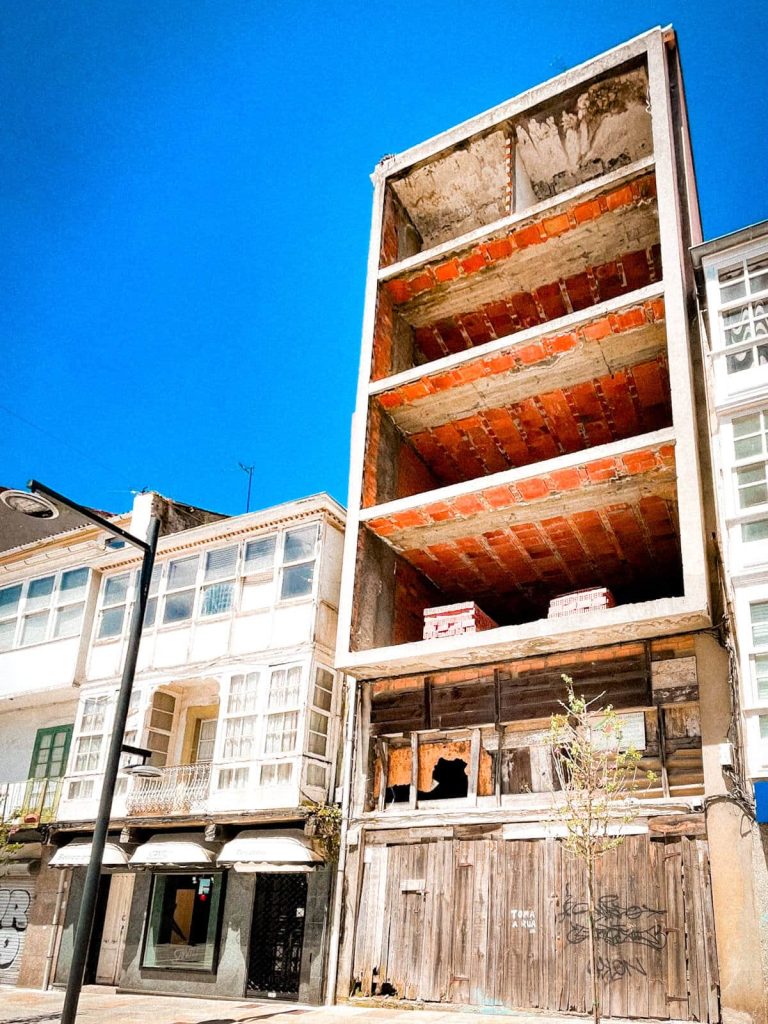Four perfectly geometric floors sit on top of a crumbling facade.