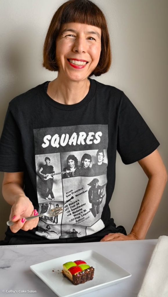 Cathy enjoys a slice of square cake in her Squares T-shirt. The Squares were Joe Satriani's first band in San Francisco in the late seventies.