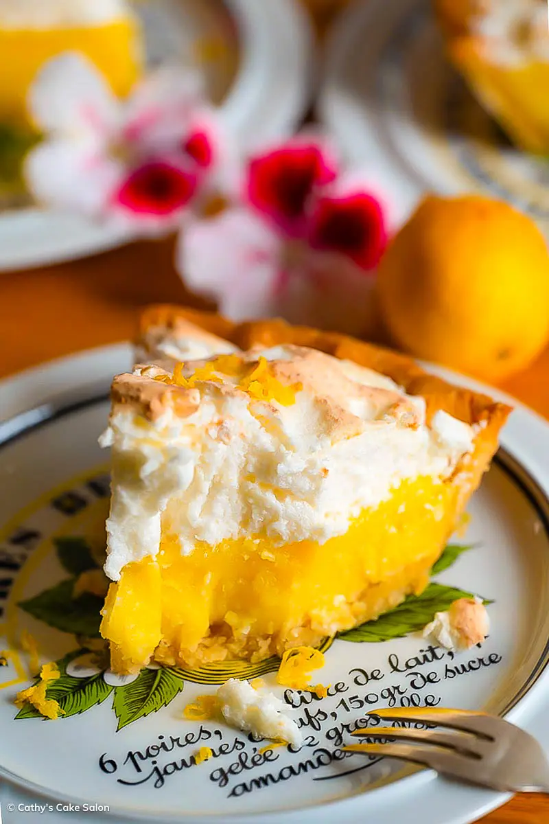 A slice of dairy free, gluten free lemon meringue pie that someone has bit into.