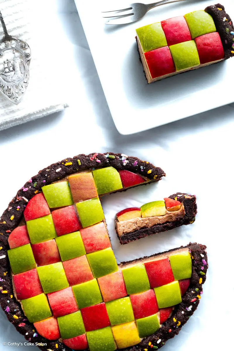 A slice of peanut butter apple pie next to the geometric vegan peanut butter chocolate pie.