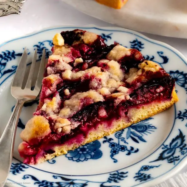 A slice of sugar free plum cake with a buttery cinnamon streusel.